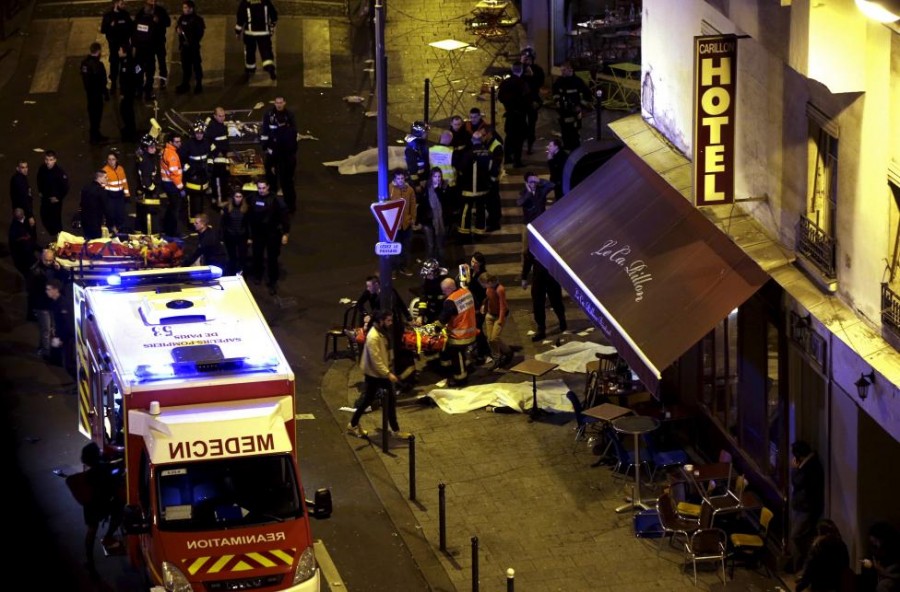 General view of the scene with rescue service personnel working near covered bodies outside a restaurant following shooting incidents in Paris, France, November 13, 2015. REUTERS/Philippe Wojazer
